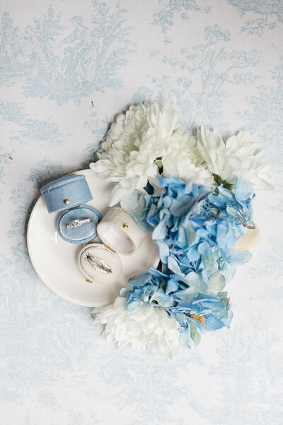 The Corteses Newport Wedding Photographer and Videographer | Serving CT, RI, and beyond | Two vintage blue and light blue ring boxes with rings with florals