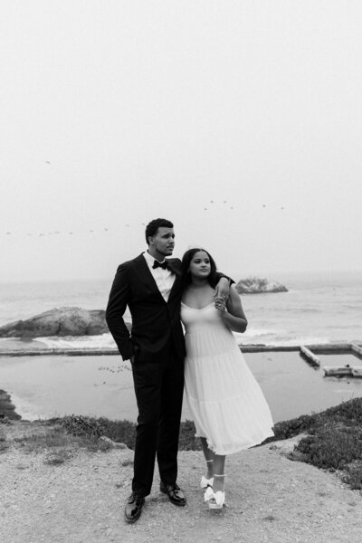 newlyweds standing on beach