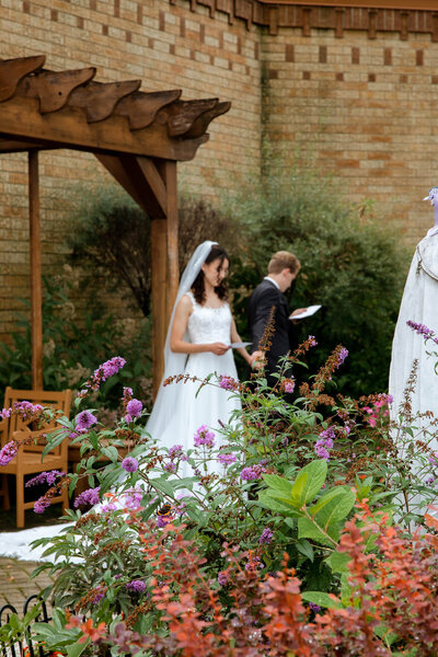Couple saying their vows at the end of their aisle during their rural wedding in Minnesota