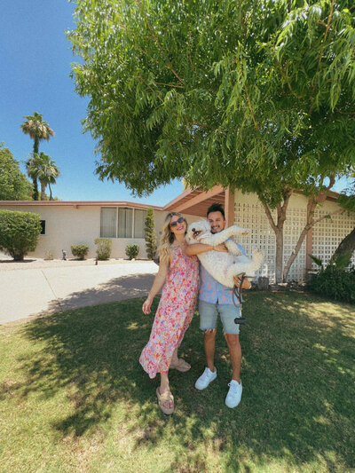 Arizona Photographers taking a photo in front of their new house.