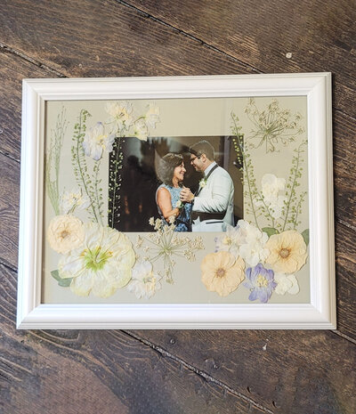 Custom floral keepsake design by Leigh Florist featuring beautifully preserved blooms in a framed display.