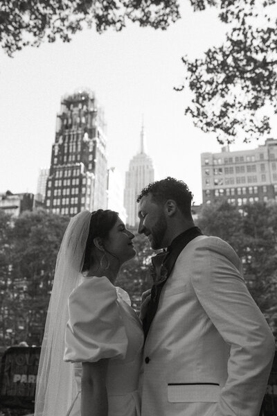 bride and groom looking at each other with skyscrapers in the background