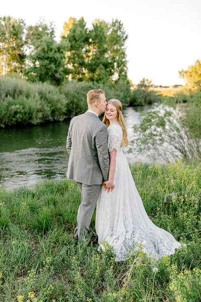 wedding couple by river in Rexburg Idaho