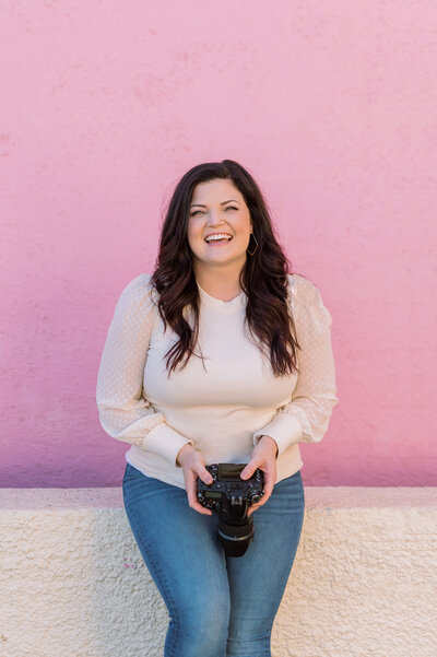 Wedding photographer headshot with a pink background