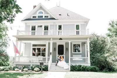 Couple sitting on porch before their wedding. Photo by Upper Case L Photography
