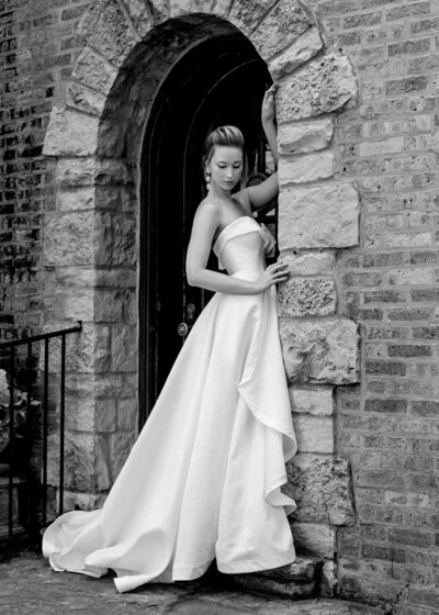 A black and white photo of the Eloise style. It's a strapless textured a-line wedding dress by Charleston bridal designer Edith Elan.