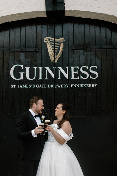 a bride and groom holding each other and laughing