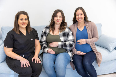 Two pregnant women smiling on a touch