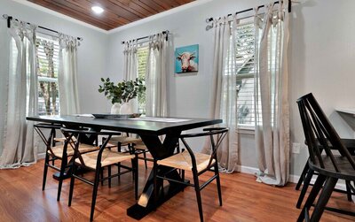 Dining room with seating for six in this three-bedroom, two-bathroom vacation rental home with historical charm in Waco, TX.