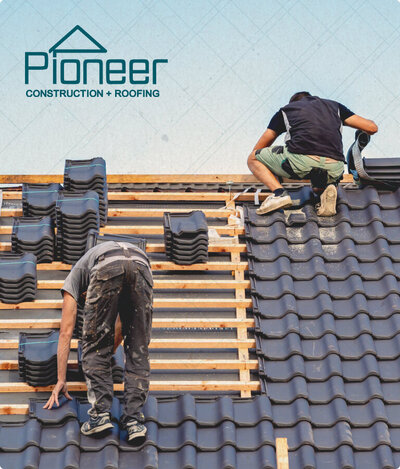 Men working on a roof with Pioneer Construction logo floating up top.