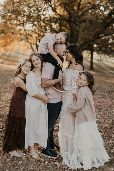 Family of 6 embracing and cuddling. 