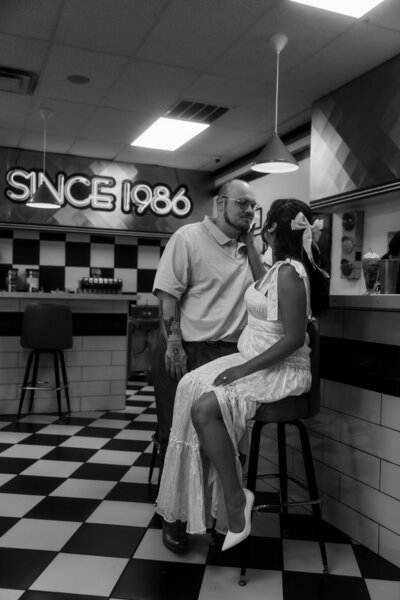 Couple celebrating their engagement with a save-the-date session at a classic diner in Utah, captured by Lamblight Photography