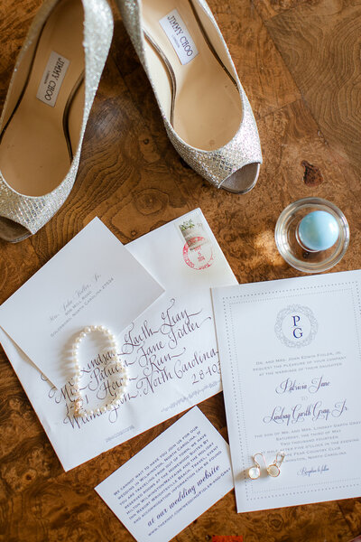 Wedding details including brides shoes, paper goods and jewels
