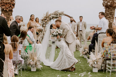newlyweds kiss behind veil