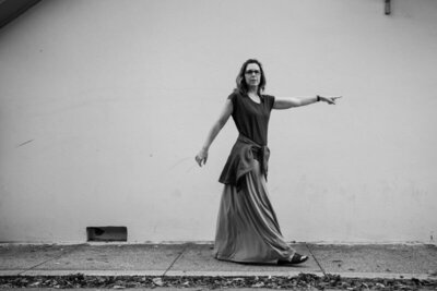 jill walking while pointing in black and white