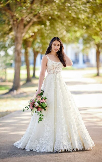 LACE AND TULLE A-LINE WEDDING DRESS WITH SQUARE NECKLINE The perfect complement to a modern love story, minimalists and romantics alike will adore this style from Martina Liana. Style 1244 features a classic, structured A-line silhouette with the ever-trending square neckline and wide straps. A striking contrast of bold laces and tiny 3D florals add coverage to the otherwise sheer bodice for a surprising twist, while slight shimmer elements add a subtle glow. The organic laces scatter down the full skirt, as the 3D florals of chiffon and organza petals increase in size toward the large floral motifs along the organic hemline. A low, open scoop back brings a simple yet timeless elegance to the design, while a subtle train completes the look with a light and airy finish.