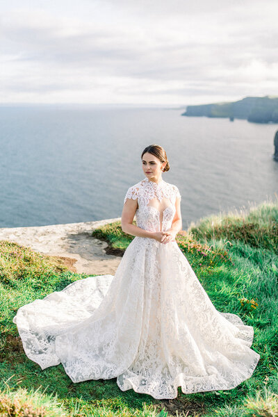 Bride Posing on Cliffside at Luxury Coastal California Wedding