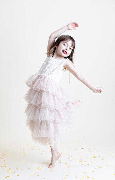 Little girl dancing in photography studio