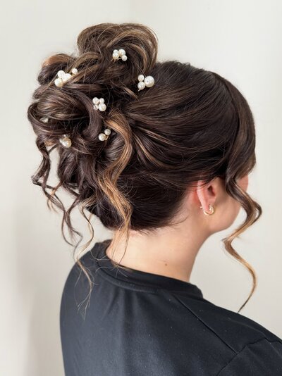 high messy updo on dark hair