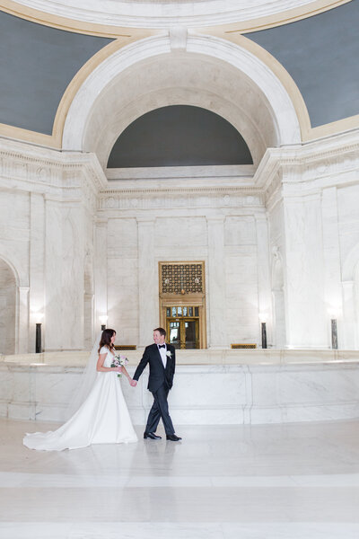 Bride and groom walk up memorial steps at their DC wedding