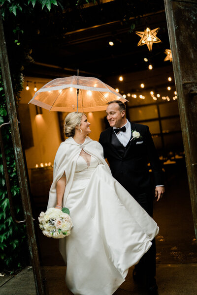 Couple celebrates after getting married at JM Cellars venue in Woodinville, Washington, popular winery venue in Seattle