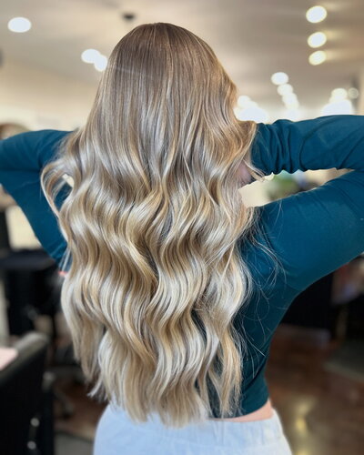 Close-up of lived-in blonde waves, showcasing Maven + Grace’s signature color work and attention to hair health.