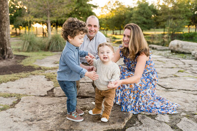 a family plays at Mueller Lake Park in Austin, Texas