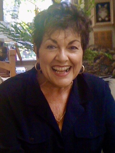 Suzanne Leydecker sitting on a front porch of a home