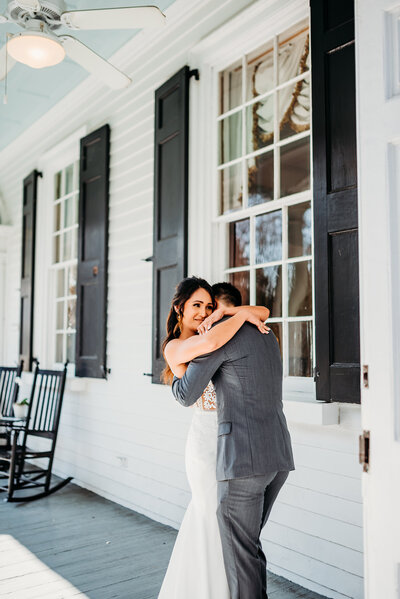 a bride and groom hugging after an emotional first look