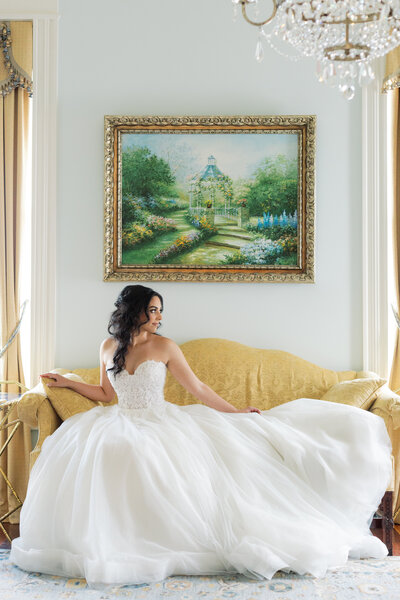 Bride wearing a veil and holding a bouquet of flowers on a summer day in Mississippi