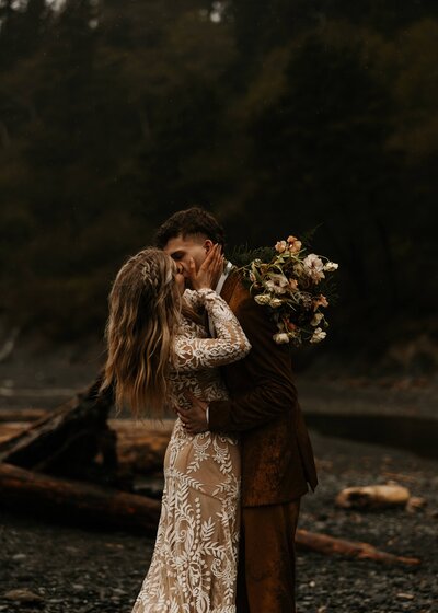 couple celebrate their marriage on a dock over a lake in the Banff mountains on elopement day