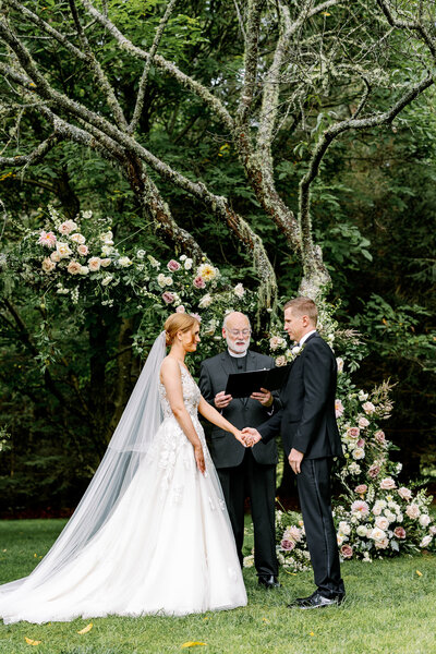 Bride and Groom with florals by Petal and Fern WNC  at The Farm at Old Edwards Inn by Maddie Moore Photo