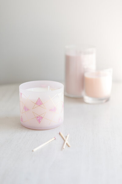 pink candles on a table with matches