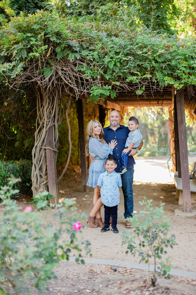 family smiles in vineyards