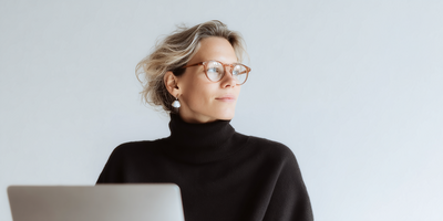 A woman in pink with closed eyes, symbolizing the emotional clarity at the start of reinvention