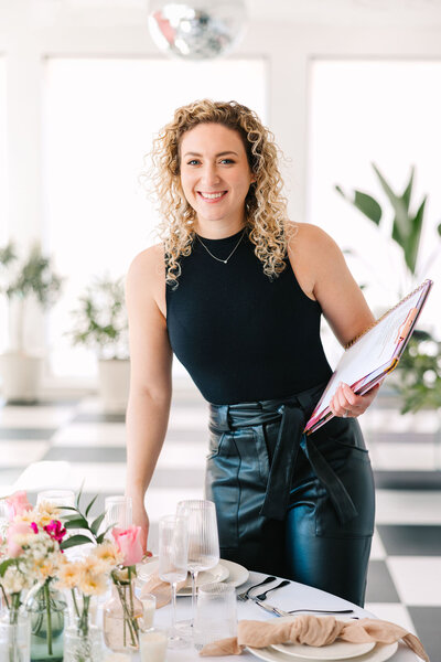 Rebecca Schwartz holding a clipboard at a wedding event