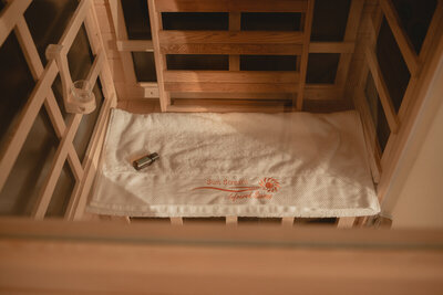 A view through the window of the Sunstream sauna into the blonde wood interior.