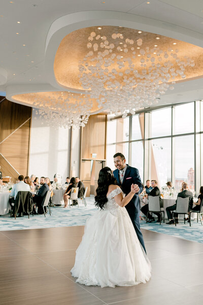 bride and groom dancing in a ballroom at a wedding reception