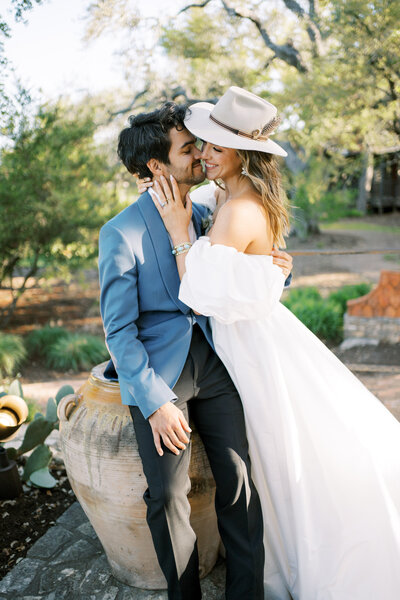 Woman in western hat and man posing for engagement photos