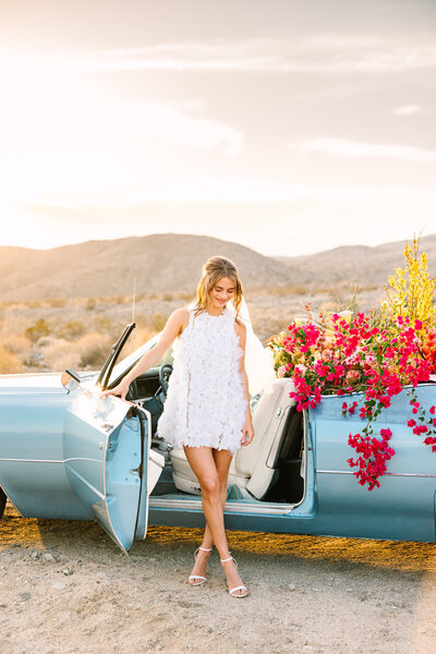 bride stepping out of vintage convertible