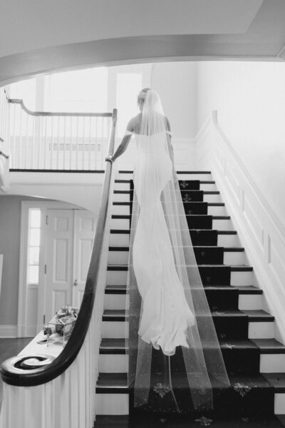 Bride stands on stairs at French House