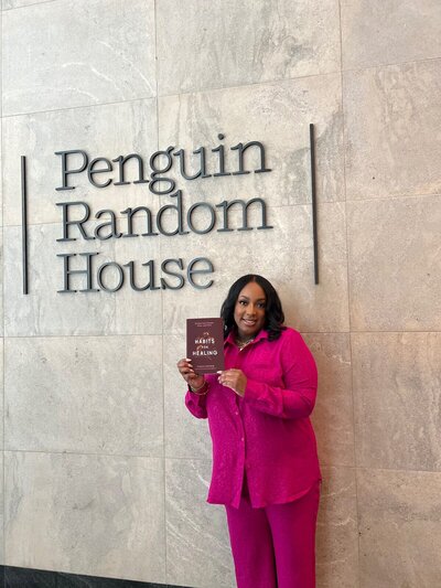 Nakeia Homer, best selling self help author holding book in front of penguin random house sign