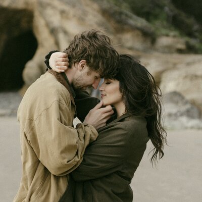 Couple embracing on windy beach