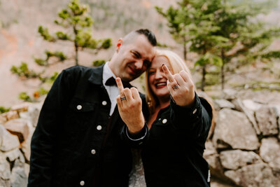 couple showing off engagement rings