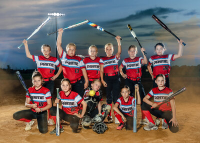 A team of young softball players hold their bats up for their Iowa sportrait photographer. 