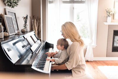 Nanny and Child playing on the piano