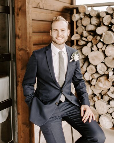 groom sitting on a stool