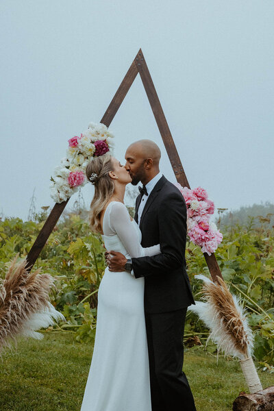 bride and groom kissing at the alter of their Alaska wedding