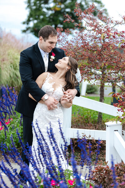 Bride and groom standing in garden at Saratoga National , NY