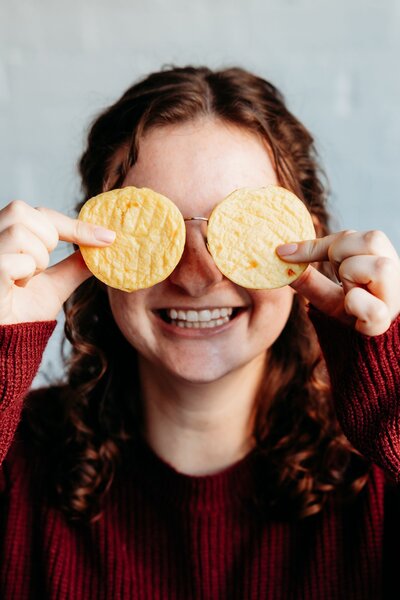 Girl covering her eyes with egg bites from Biggby Coffee.